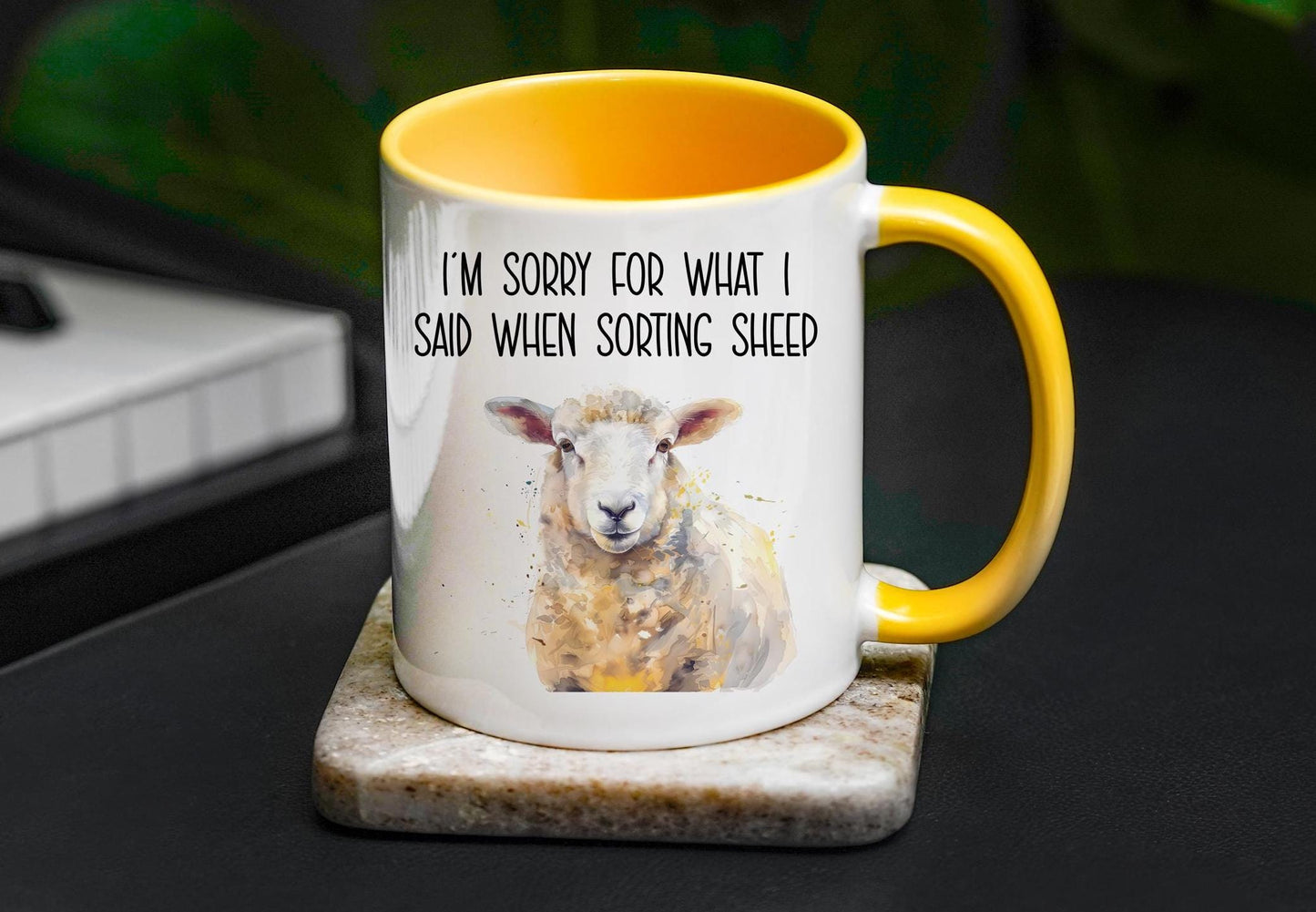 A detailed white sheep with shades of yellow and light greys, on a white mug with a golden yellow handled and inside. Black text reads &#39;I&#39;m sorry for what I said when sorting sheep&#39;